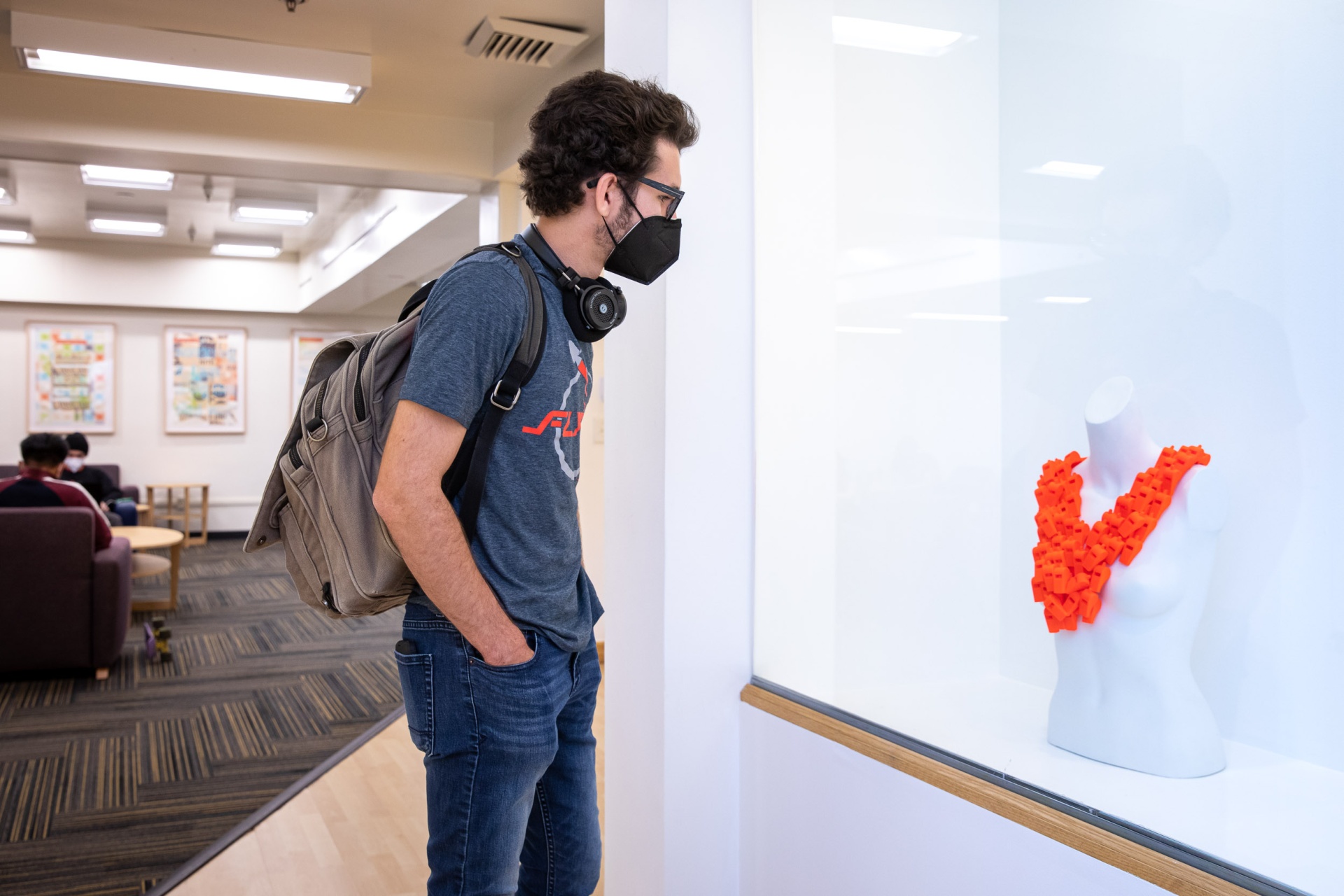 Student looks at artwork in USU Art Gallery