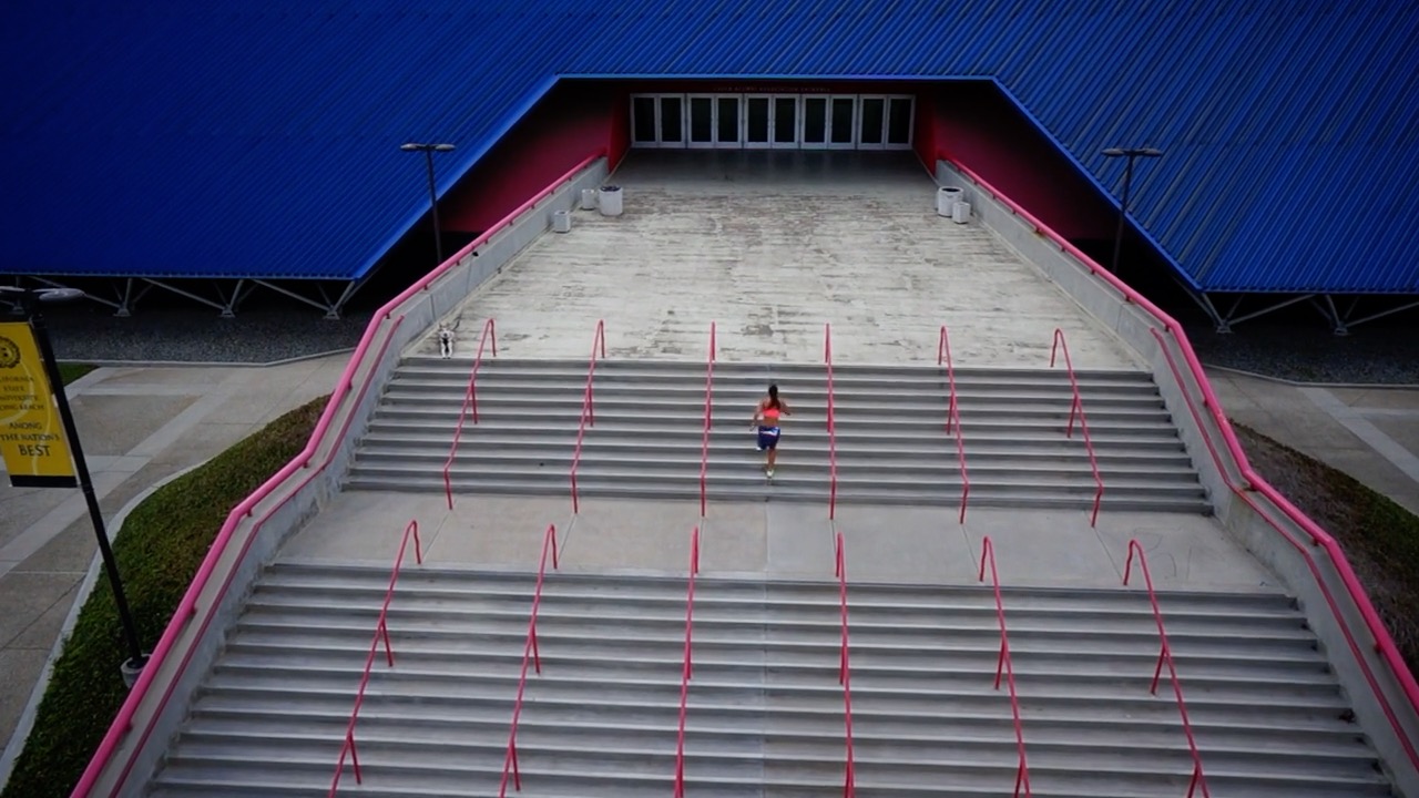 Woman runs up steps of the Pyramid.