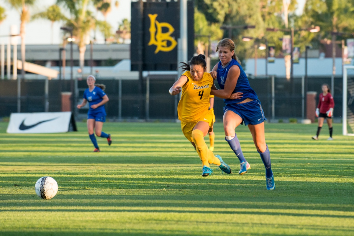 soccer game in action, two players battling over control of 