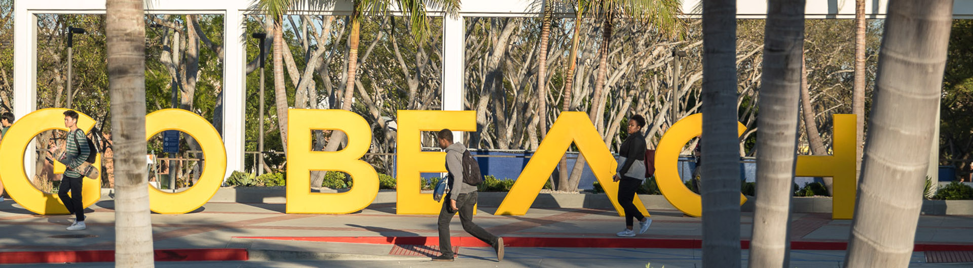 Students walk by the GO BEACH sign