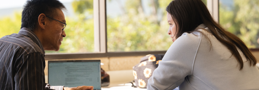 Student receiving guidance on resume writing from a counselor