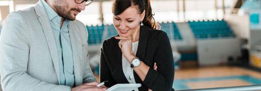 Two people talking in a sports arena