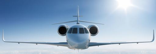 A jet plane with its head facing forward glides through clear blue skies.
