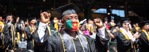 Graduate standing in crowd at commencement