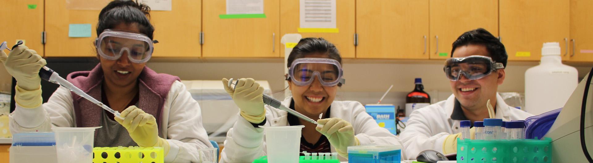 students pipetting in a research lab