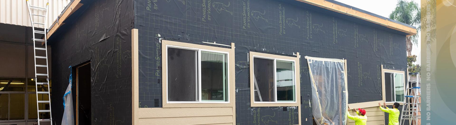 Workers building tiny house