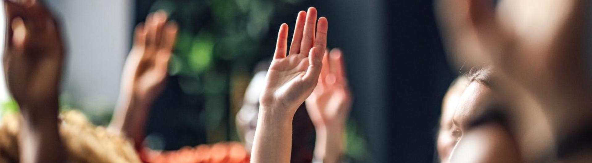 raised hands in a classroom