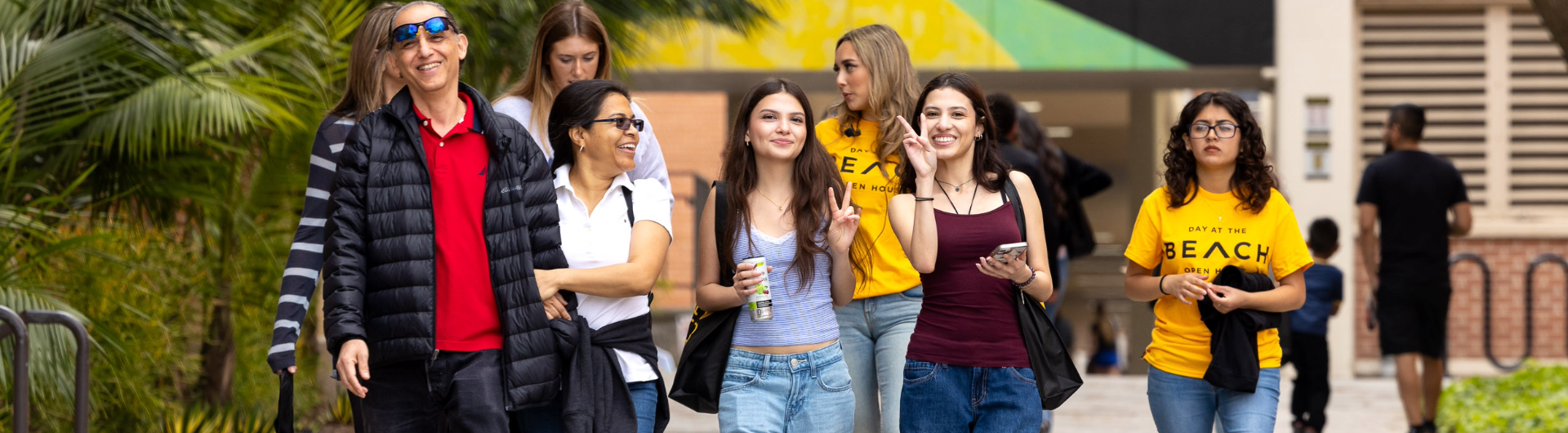 Students walk on campus and flash peace signs
