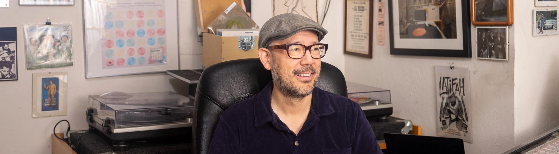 Professor Oliver Wang smiles in his office