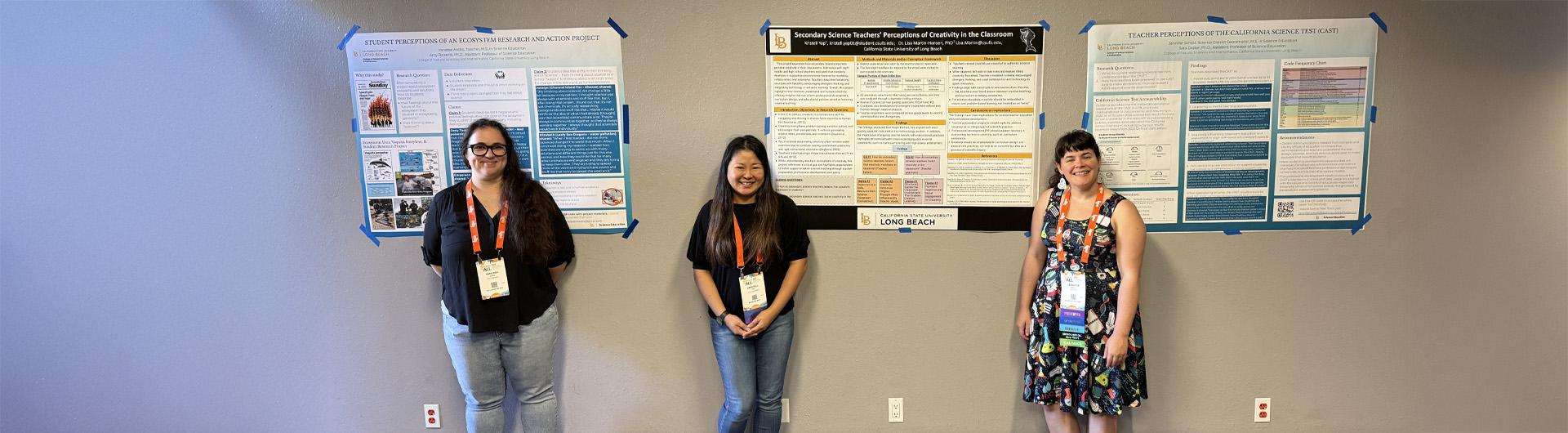 students standing by their research posters