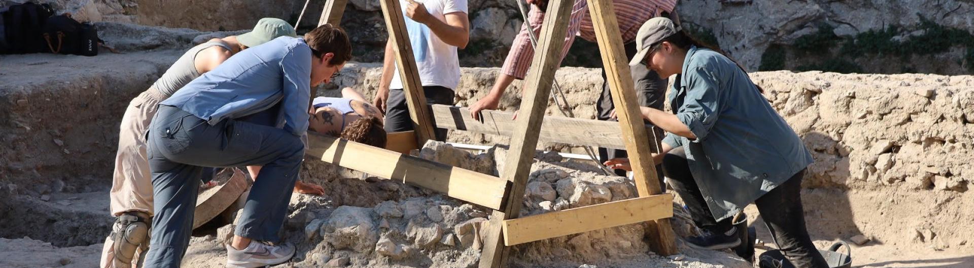 archaeologists looking into a dig