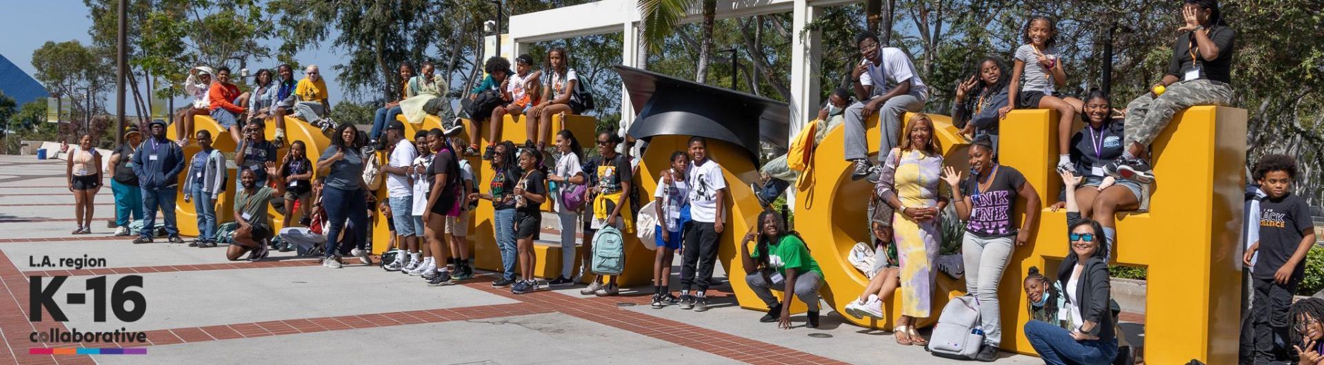 Sankofa students at the Go Beach sign