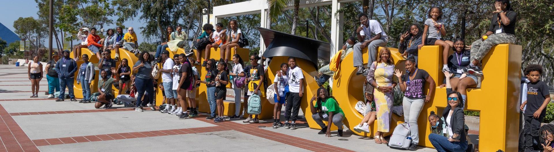 Sankofa students at the Go Beach sign