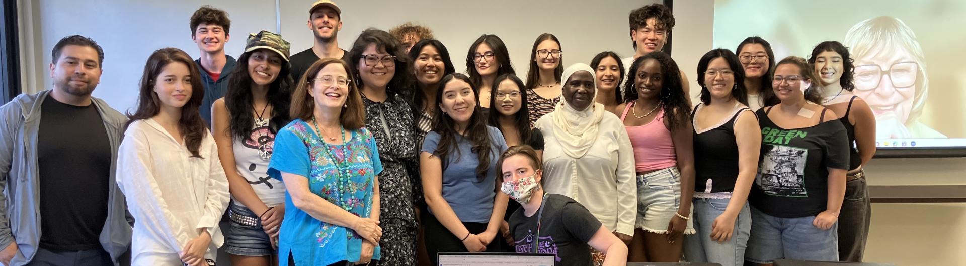 people standing by a screen