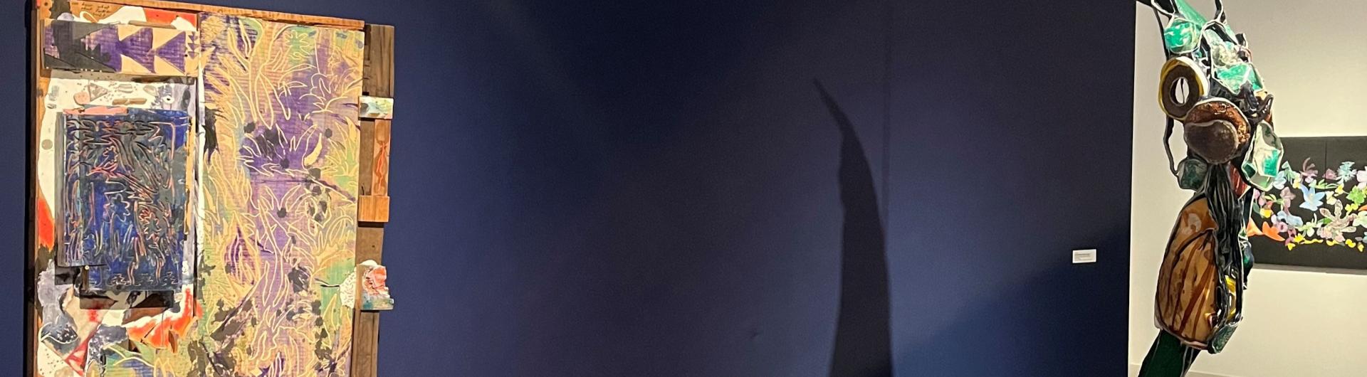 pieces of art in front of a navy blue wall