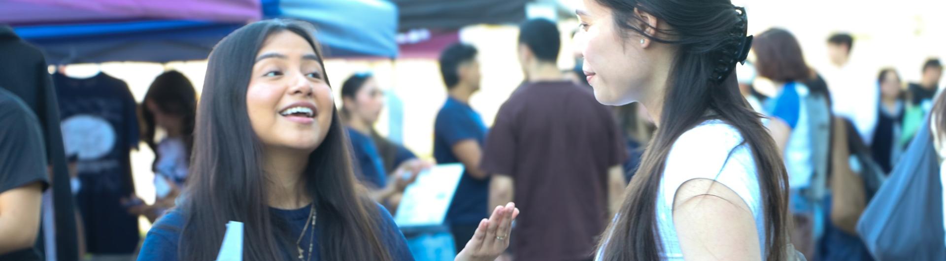 COB CSS get down to business 2026 two females talking at event