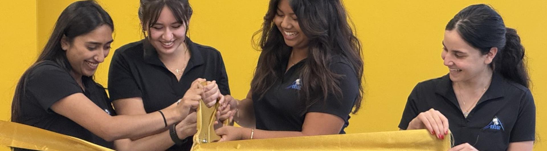 COB ABSOC RIBBON CUTTING 4 girls cutting