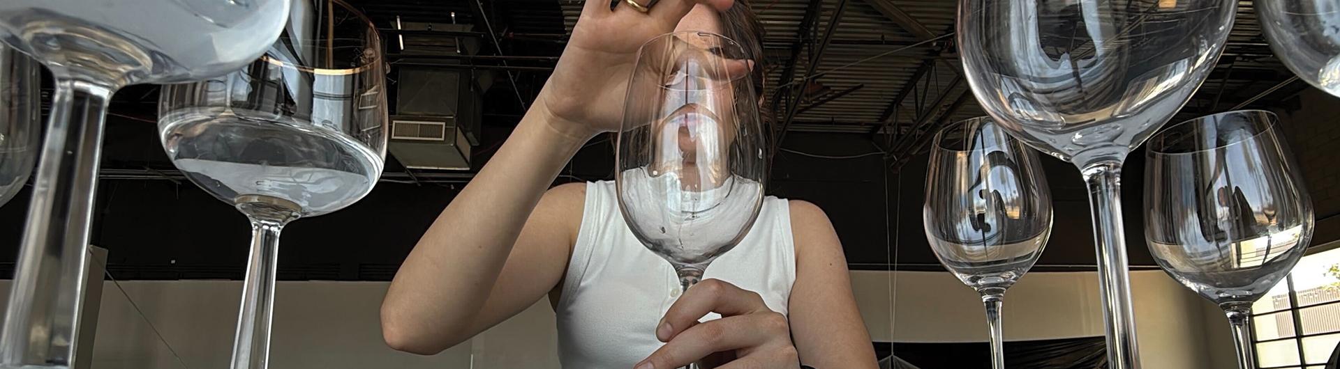 Student experimenting with wine glasses