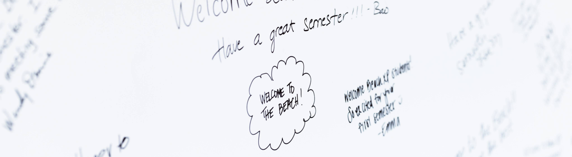 a white board with a message that reads welcome to the beach
