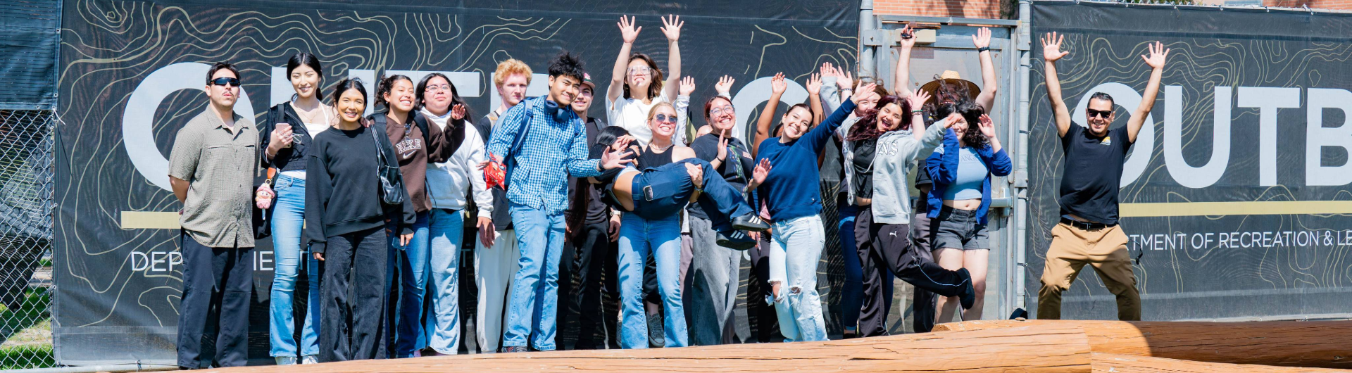 a big group of students outside smiling
