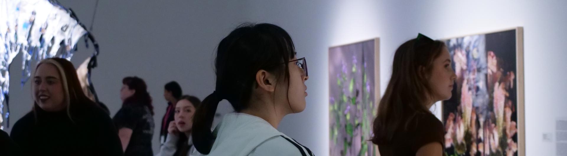 Several students exploring art galleries