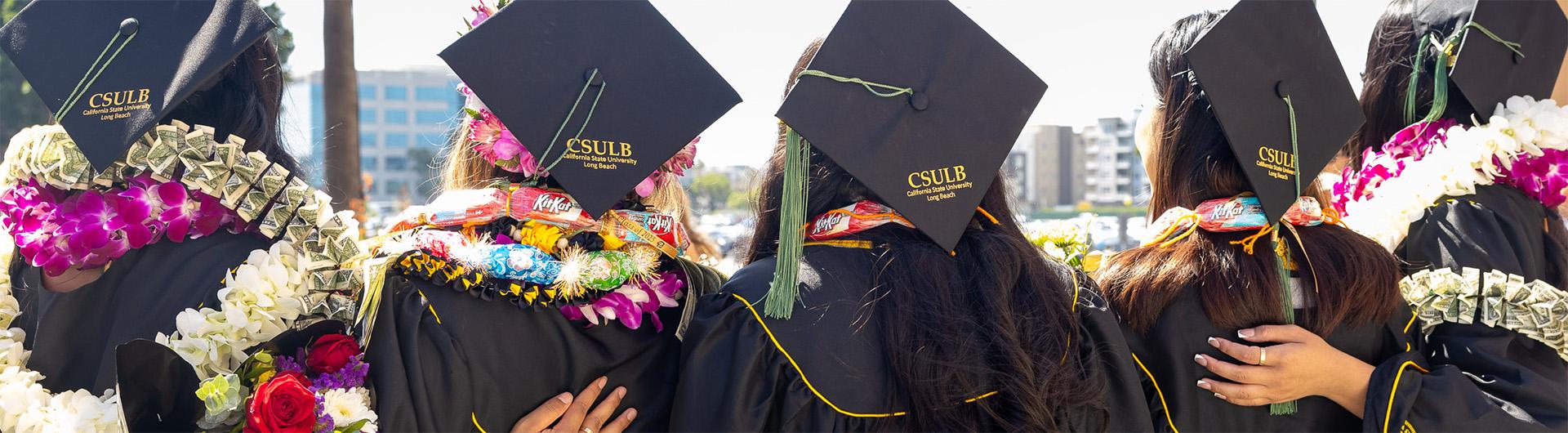 students wearing graduation caps and leis