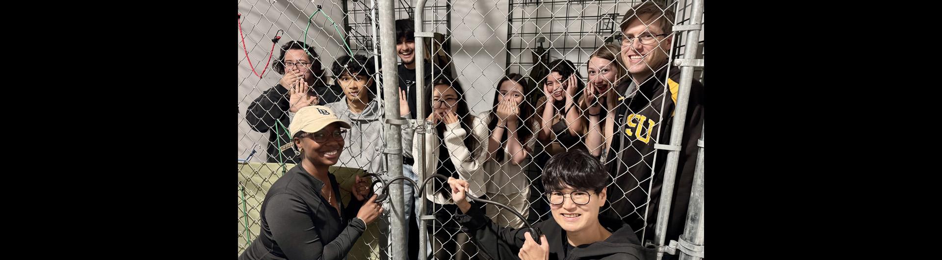 event participants behind a locked gate