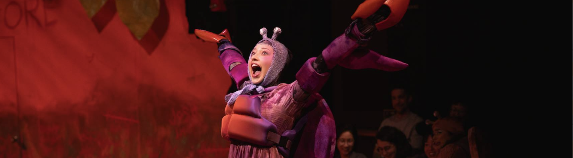 A pink crab extends her arms out in joy. 