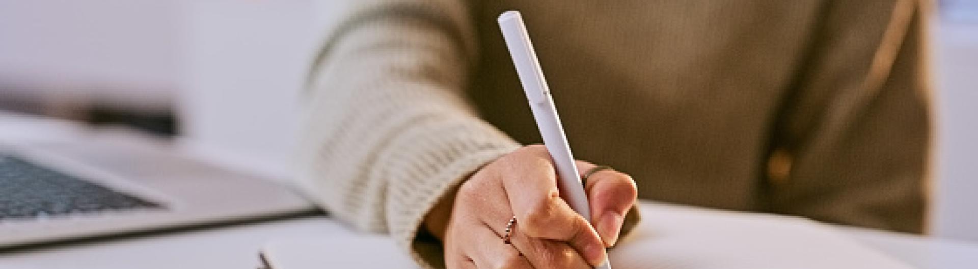 Student writing notes