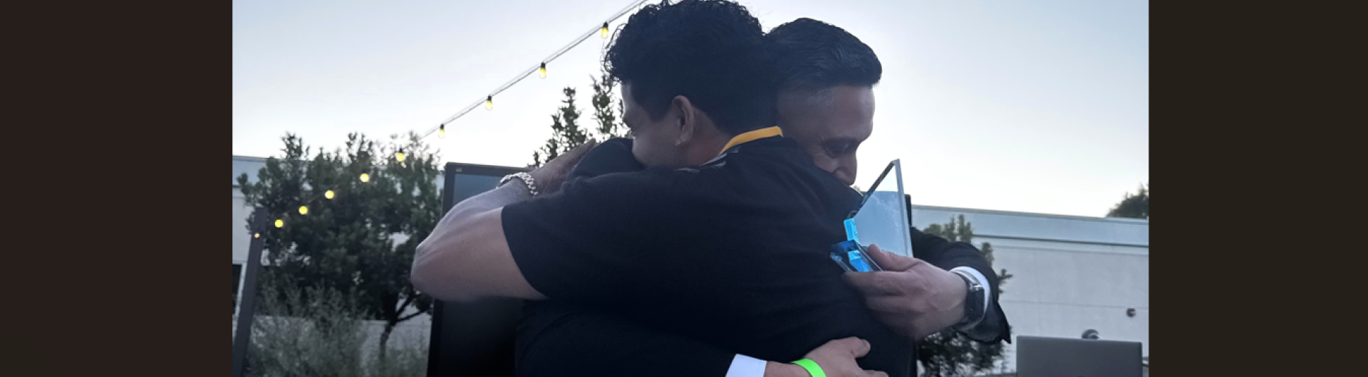 Two people hugging award 