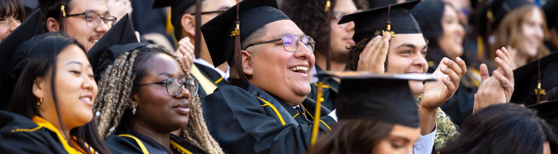 CCSULB graduates in caps and gowns celebrating at commencement