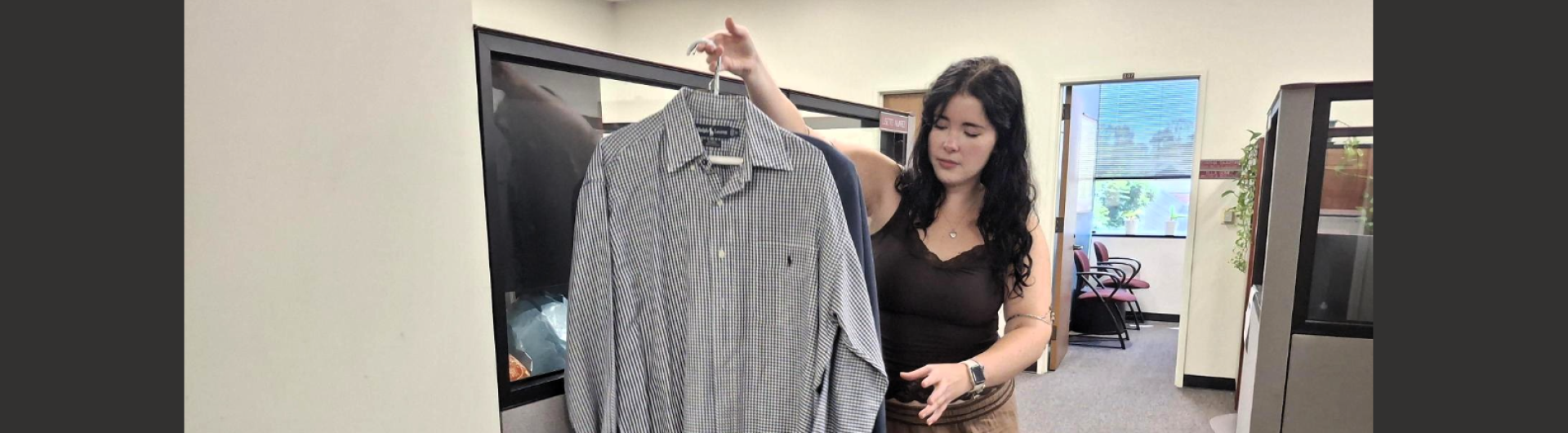 Student lifting donated shirts