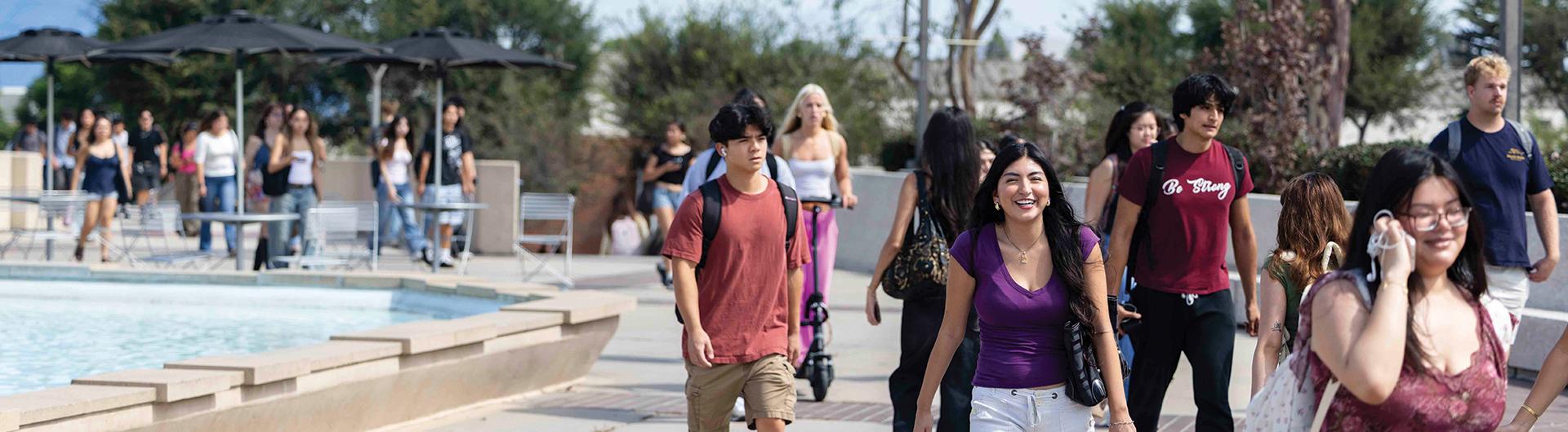 Students walking near the fountain