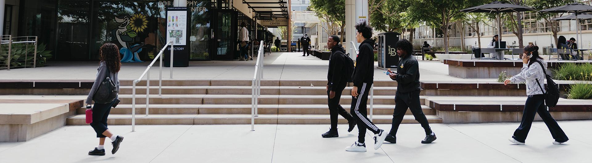 Students walking across campus in front of Bob Murphy Access Center