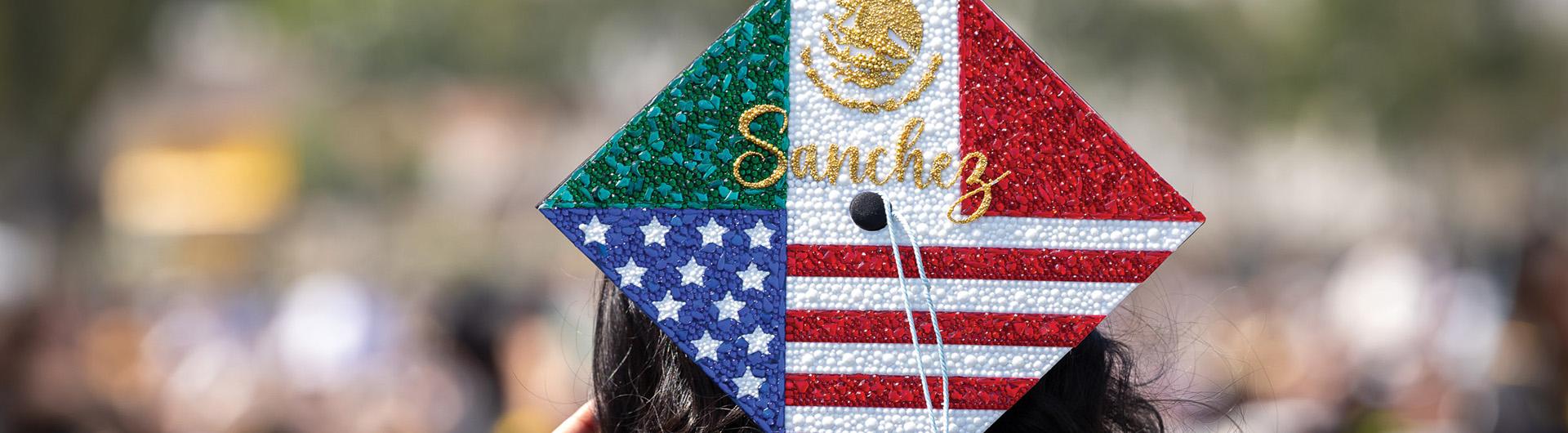 A graduation cap adorned with images inspired by the flags of Mexico and the United States