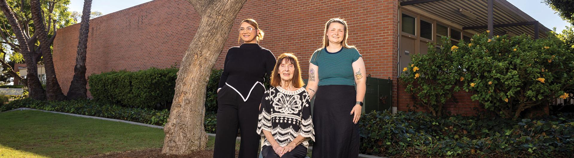 Charlotte Hamilton, Barbara Ellis and Raven Moon in front of the College of Education building