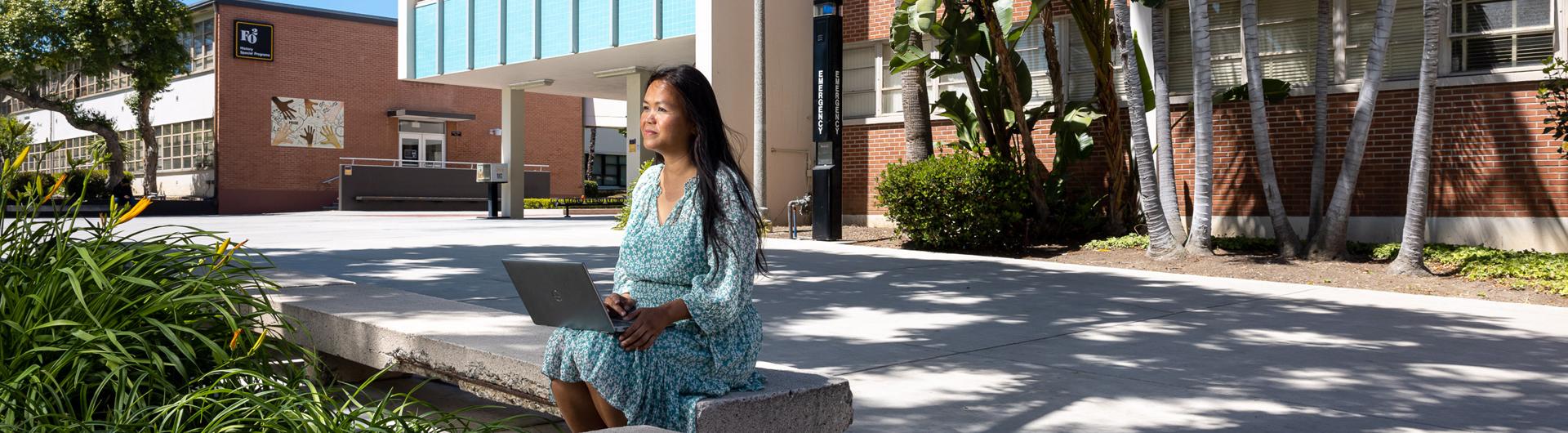 Professor Sophia Seng sitting outside on campus