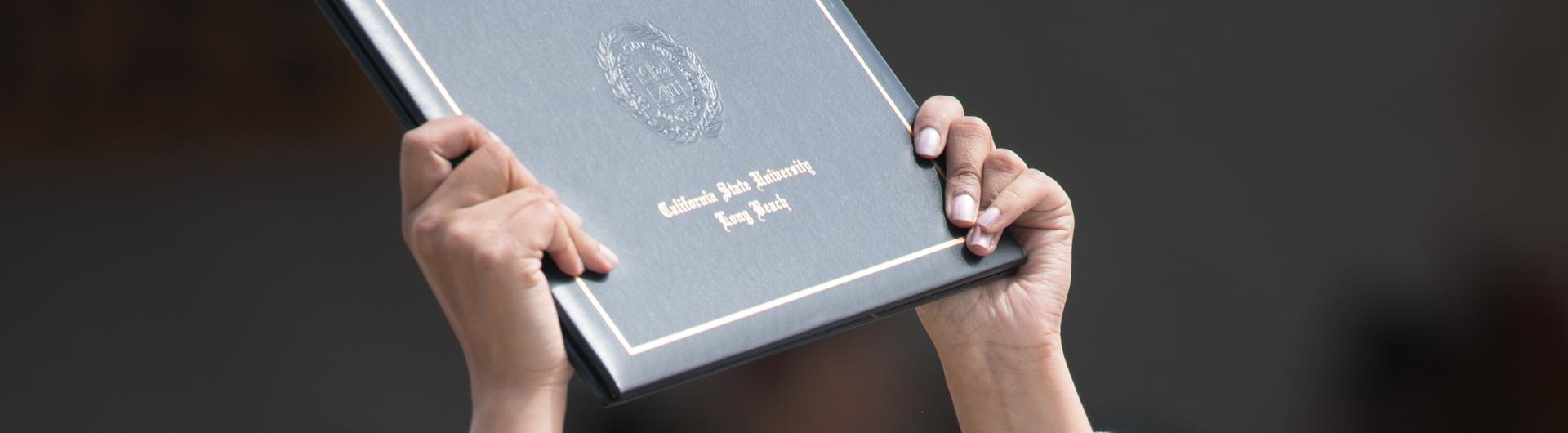 Someone holding a diploma