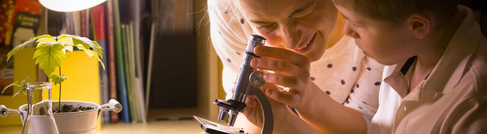 Woman and son looking at a microscope