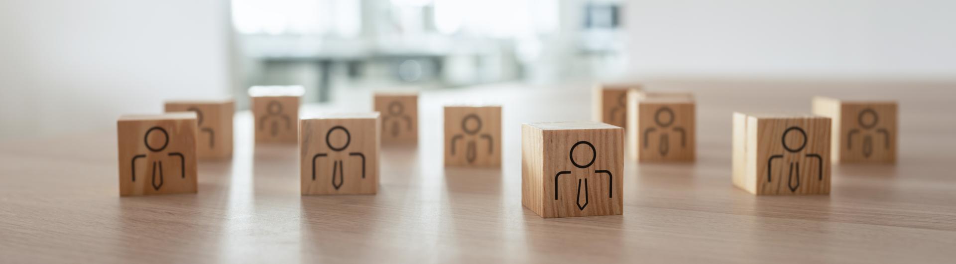 group of wooden blocks with silhouettes of people.