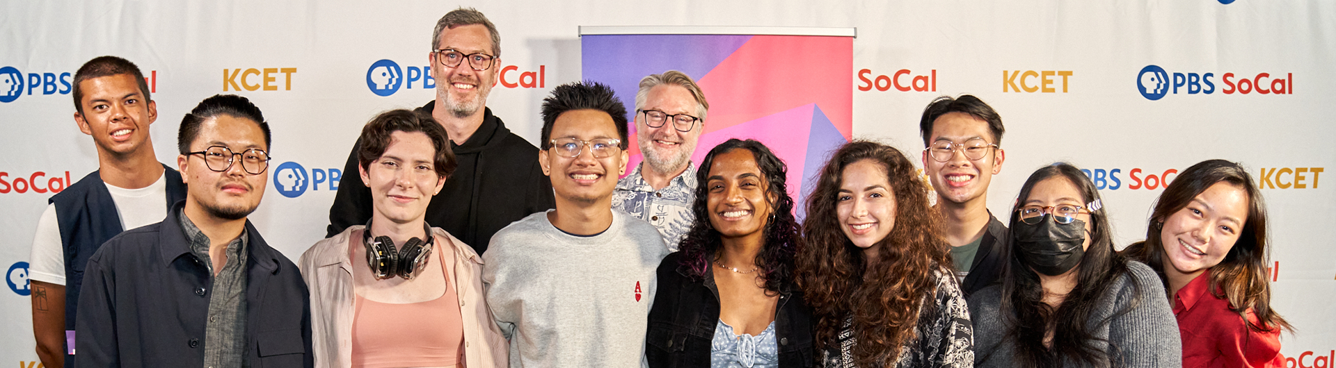 Film faculty and students at the 2022 KCET Fine Cut Festival in front of festival sign 