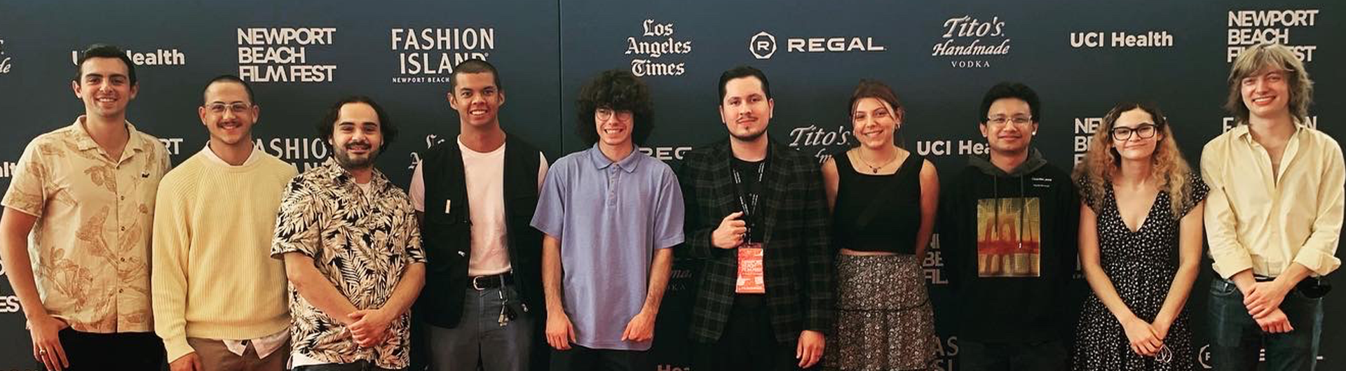 CSULB filmmakers standing in front of sign for the Newport Beach Film Festival