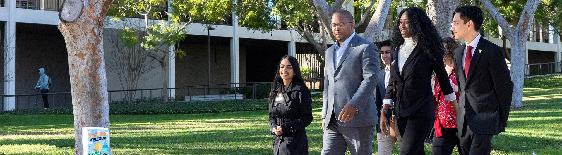 Mayor Rex Richardson walks across campus with students