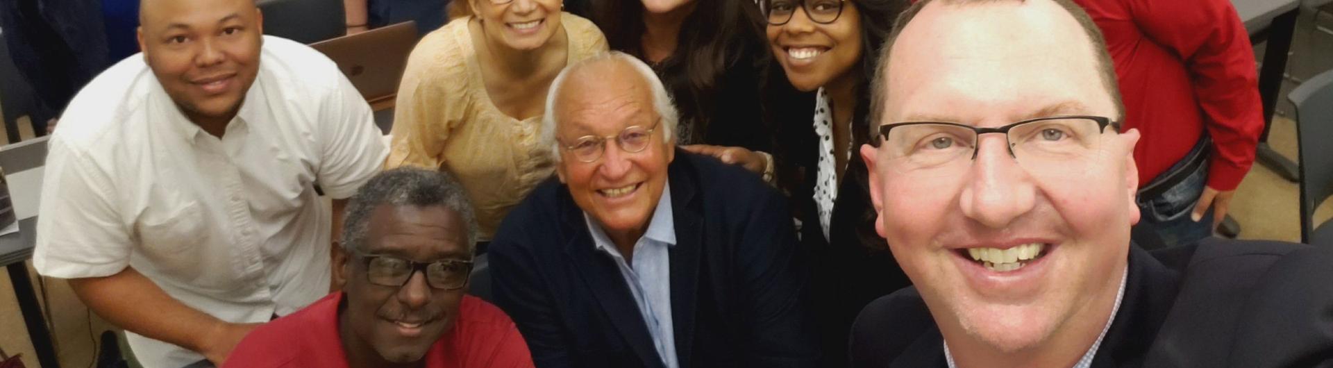 Bill Vega poses with a group of students