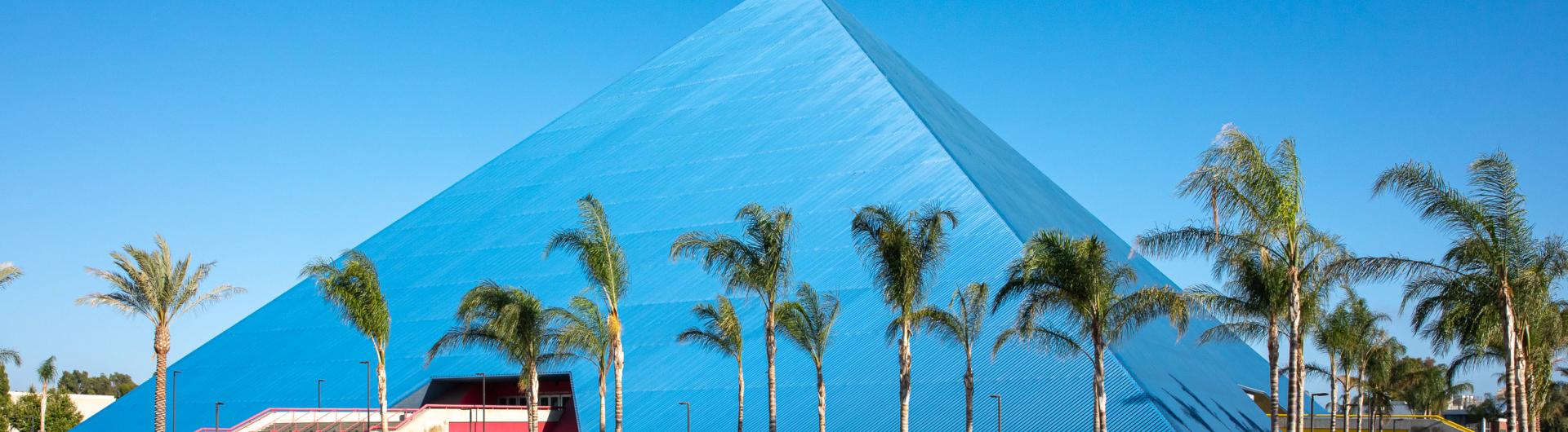 Pyramid with palm trees in forefront