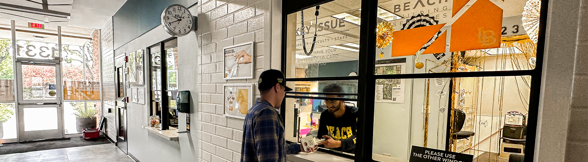 Person at the Key Issue window receiving a giant key