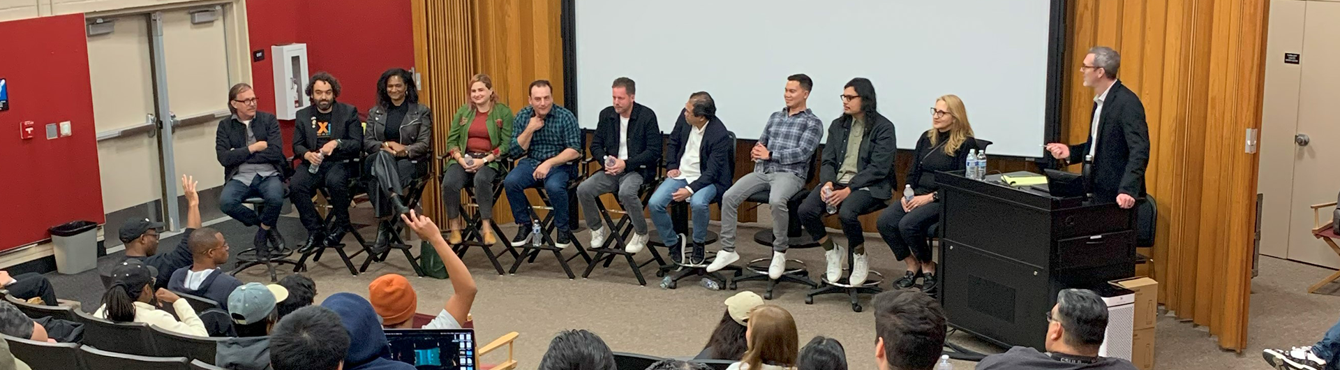 panel of film alums sitting in directors chairs