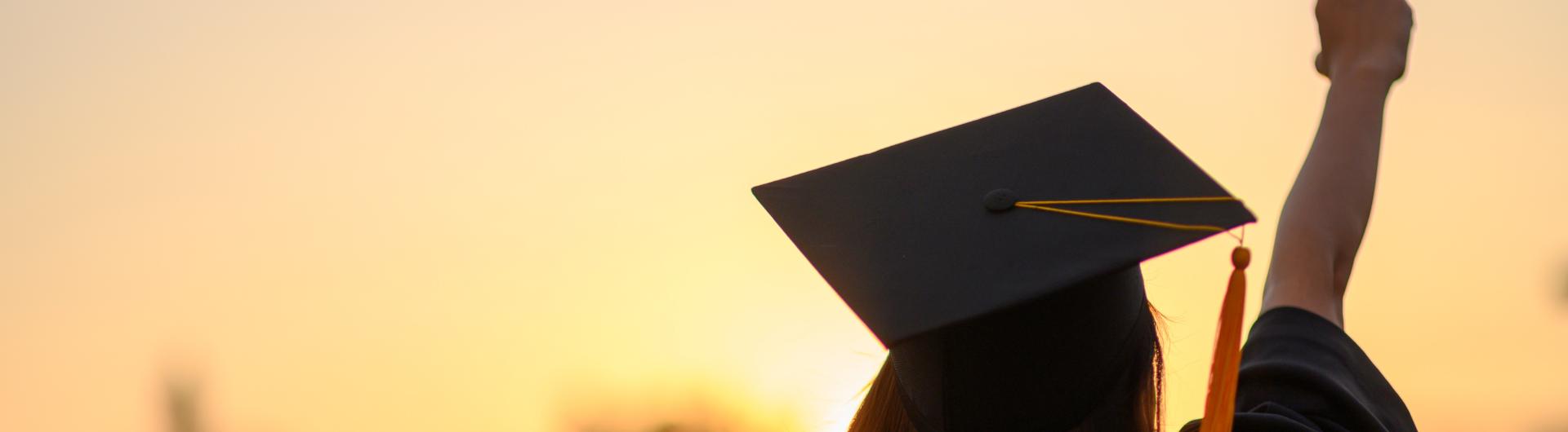 Graduate with arm up.