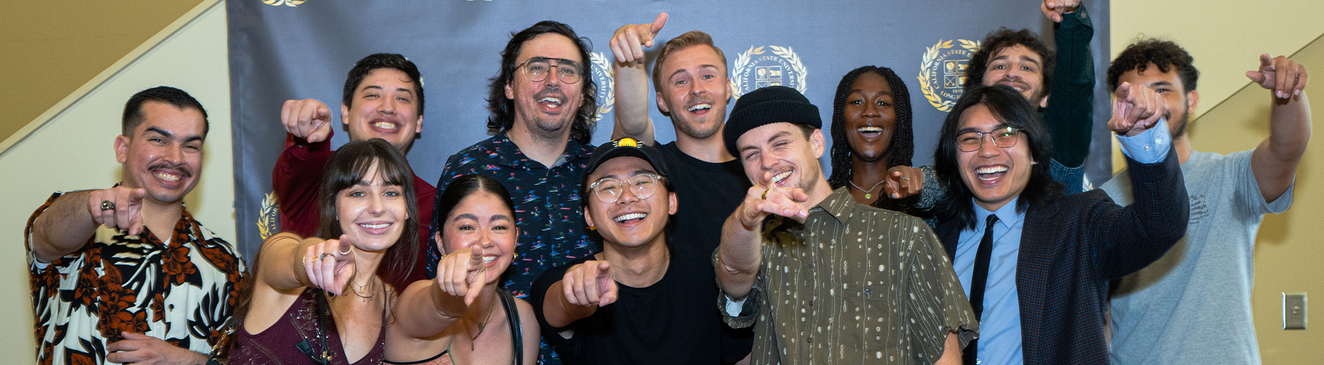 Group of CSULB Film students in front of CSULB Seal backdrop