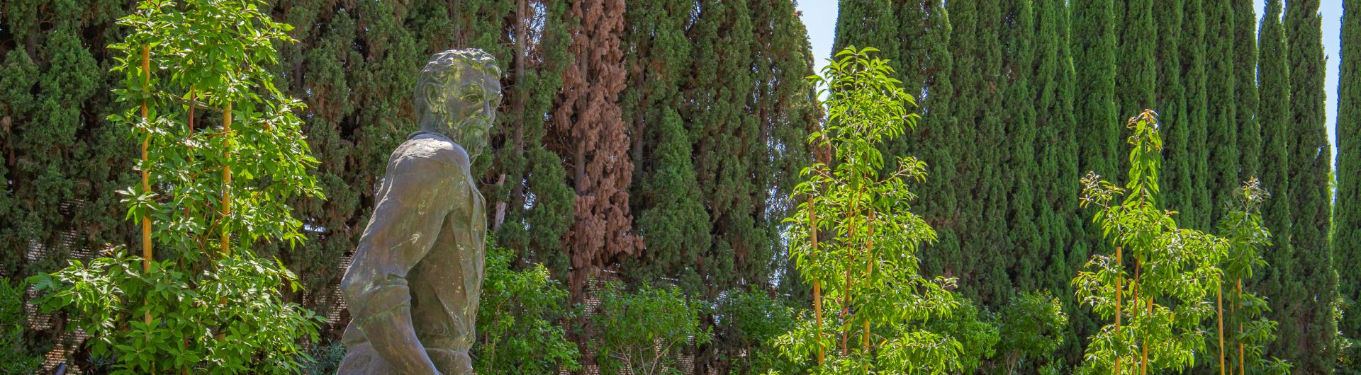 Statue on campus and greenery